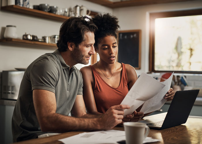 Young couple looking through paperwork