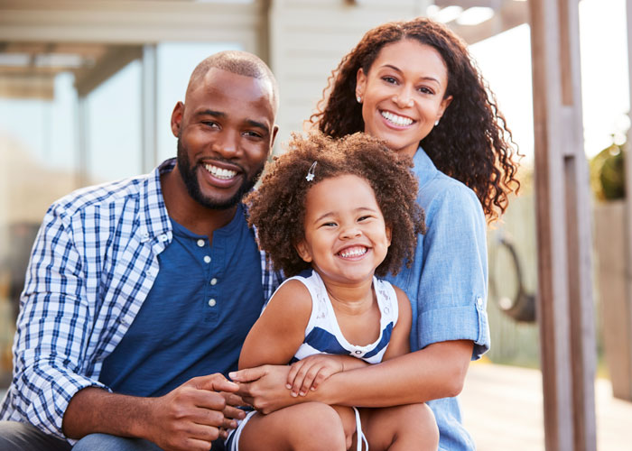 Family of three posing for a family picture