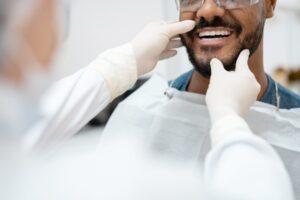 The Dentist checking a man teeth for dental implant at Atlanta, GA