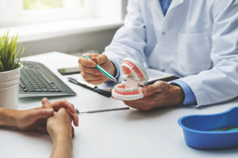 The Dentist discussing with his patient regarding the implantation surgery , GA