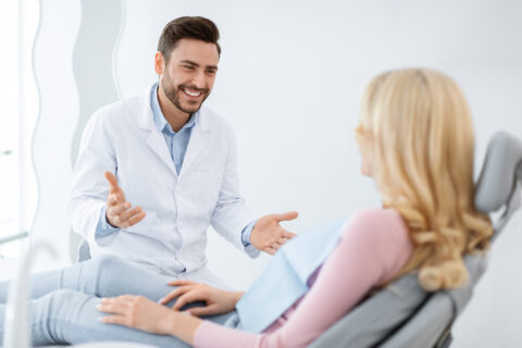 Friendly dentist having conversation with patient