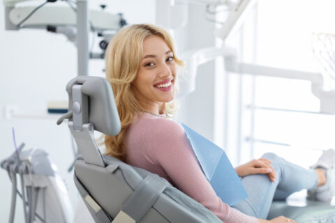 Young woman sitting at dental chair