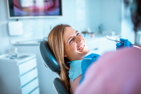 Woman happily gets treatment from dentist for implantation, GA