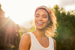 The Young woman smiling at sunset.