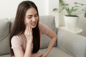 The young Women have tooth pain and suffering.