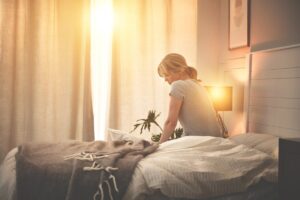 A lady wakes from sleep from tooth pain in Atlanta, GA 