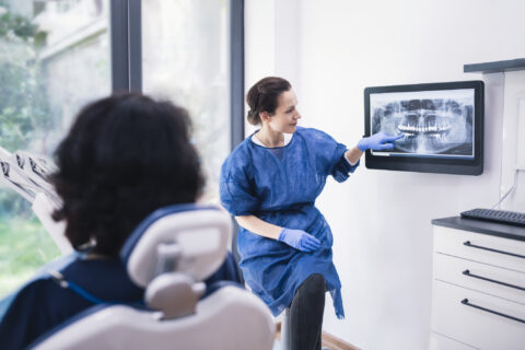 Dentist explaining tooth X-rays to a patient in Atlanta, GA