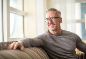 Man sitting on a sofa smiling in Atlanta, GA