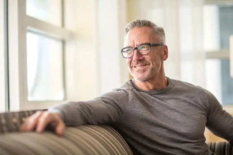 Man sitting on a sofa smiling in Atlanta, GA