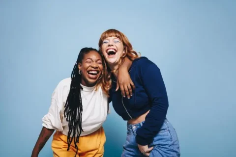 Two friends laughing and having a good time together in the studio in Atlanta, GA
