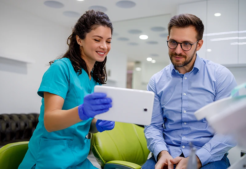 Dentist reviews dental care instructions with a patient