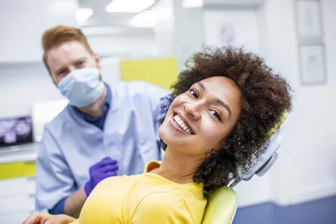 Smiling patient at dentist’s office to get replaced
