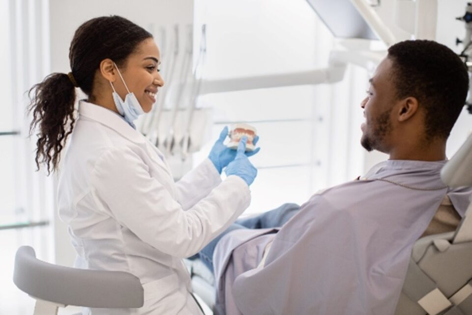 Patient receiving an oral surgery consultation