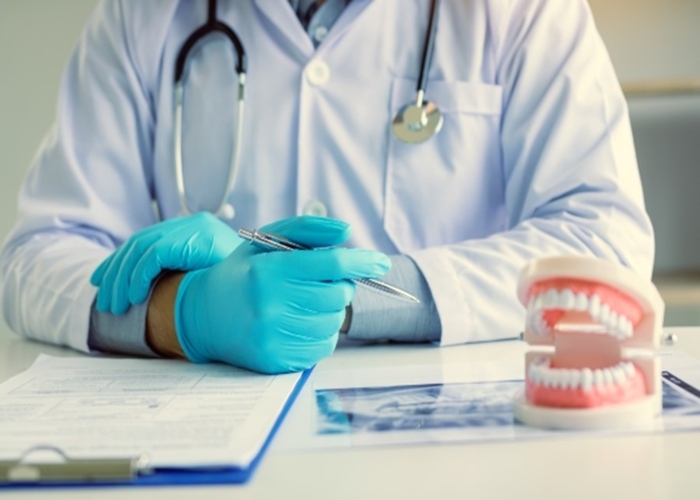 Oral surgeon sitting at a desk