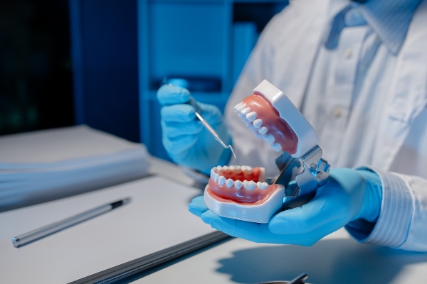 Oral surgeon with typodont model of teeth