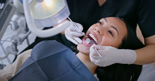 Smiling patient receiving an oral examination